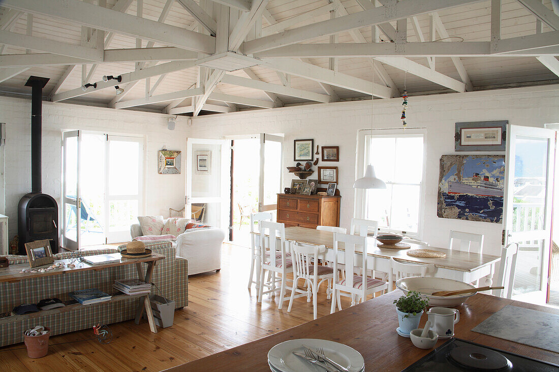 Dining and living room with wooden furniture and roof beams