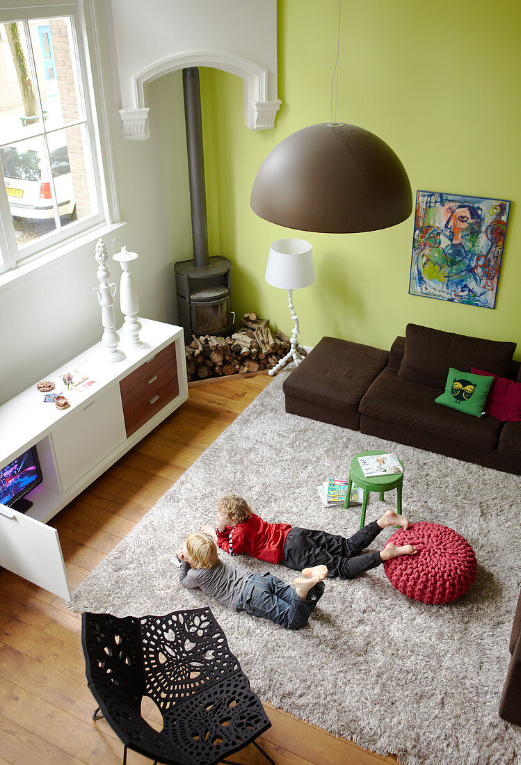 Children on a flokati rug in a modern living room