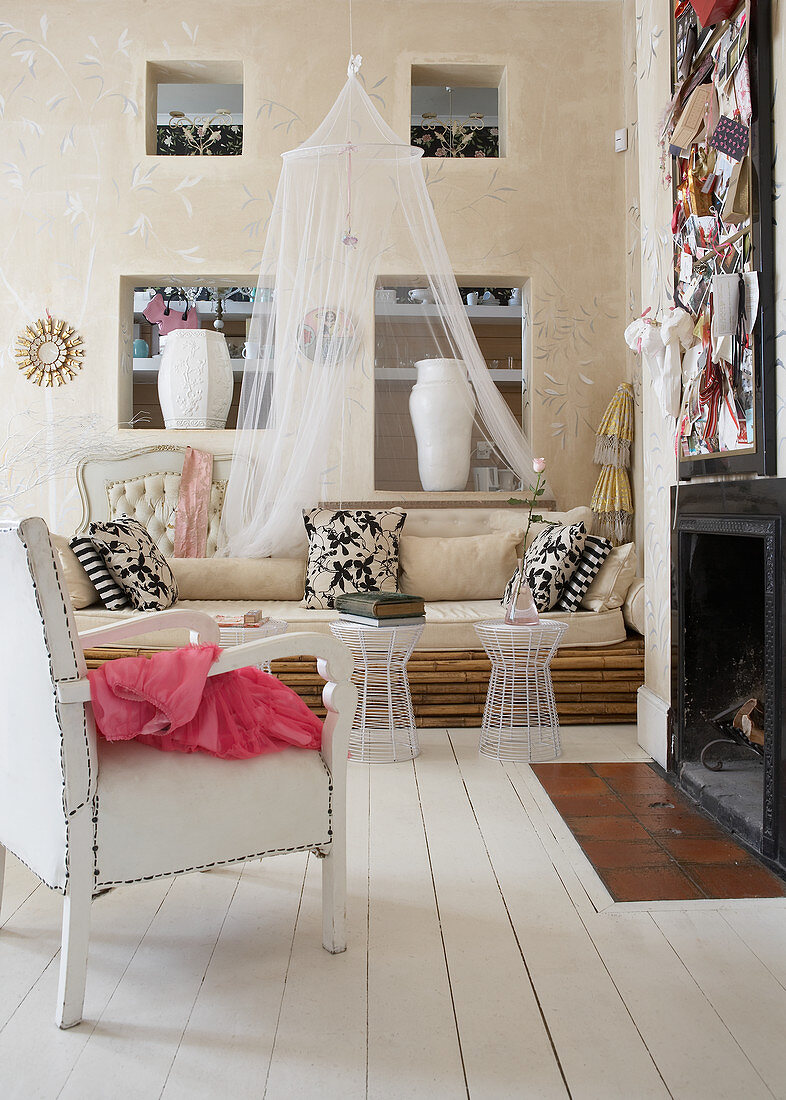 Armchair with white leather upholstery and sofa made of bamboo poles in modern country house