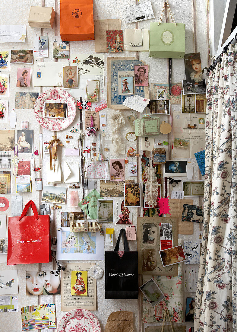 Collection of postcards and bags on wall