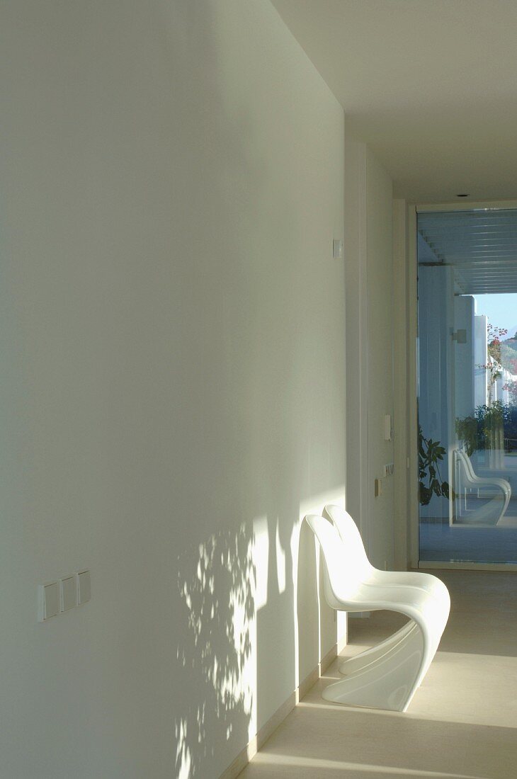 White corridor with white chairs