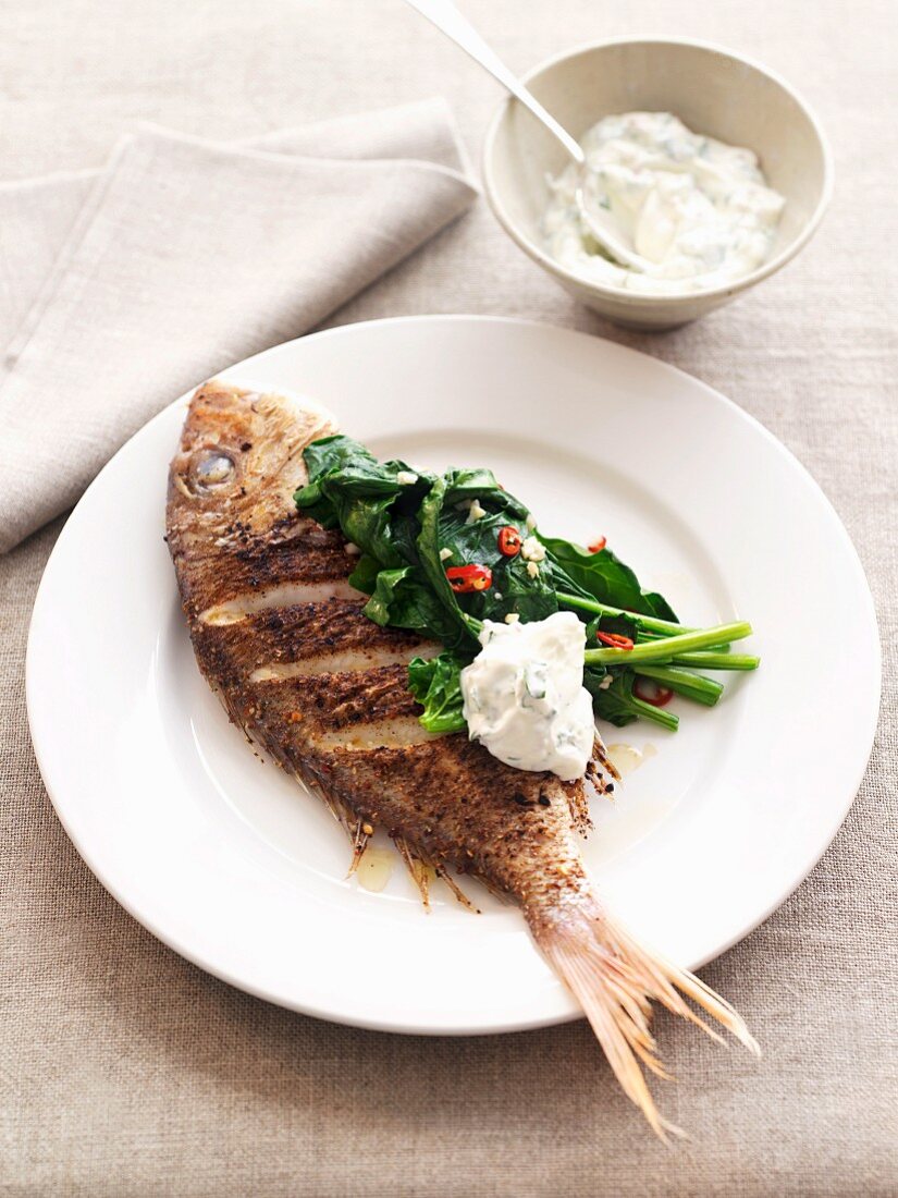 Red snapper with chermoula, spinach and coriander yoghurt sauce