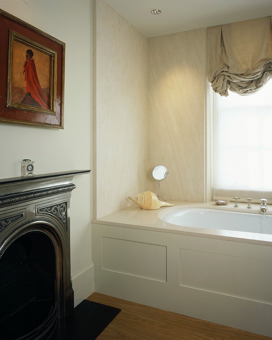 Traditional bathroom with fireplace and modern bathtub with marble-clad wall