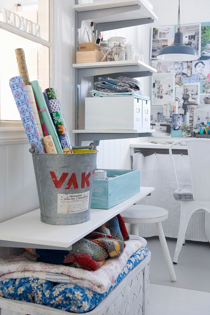 Practical shelving and baskets keeping white, shabby-chic workroom tidy