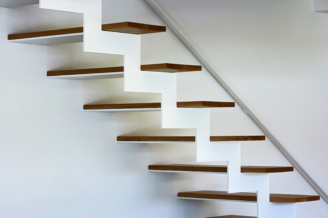 Detail of structure of modern designer staircase with zigzag framework and wooden treads