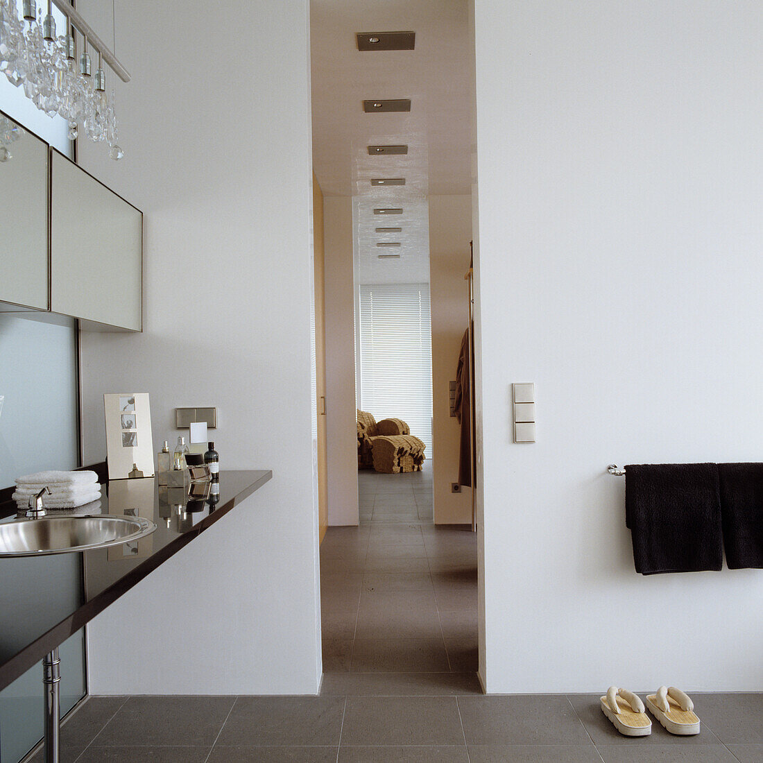 Bathroom with white walls, black washbasin and mirror cabinet