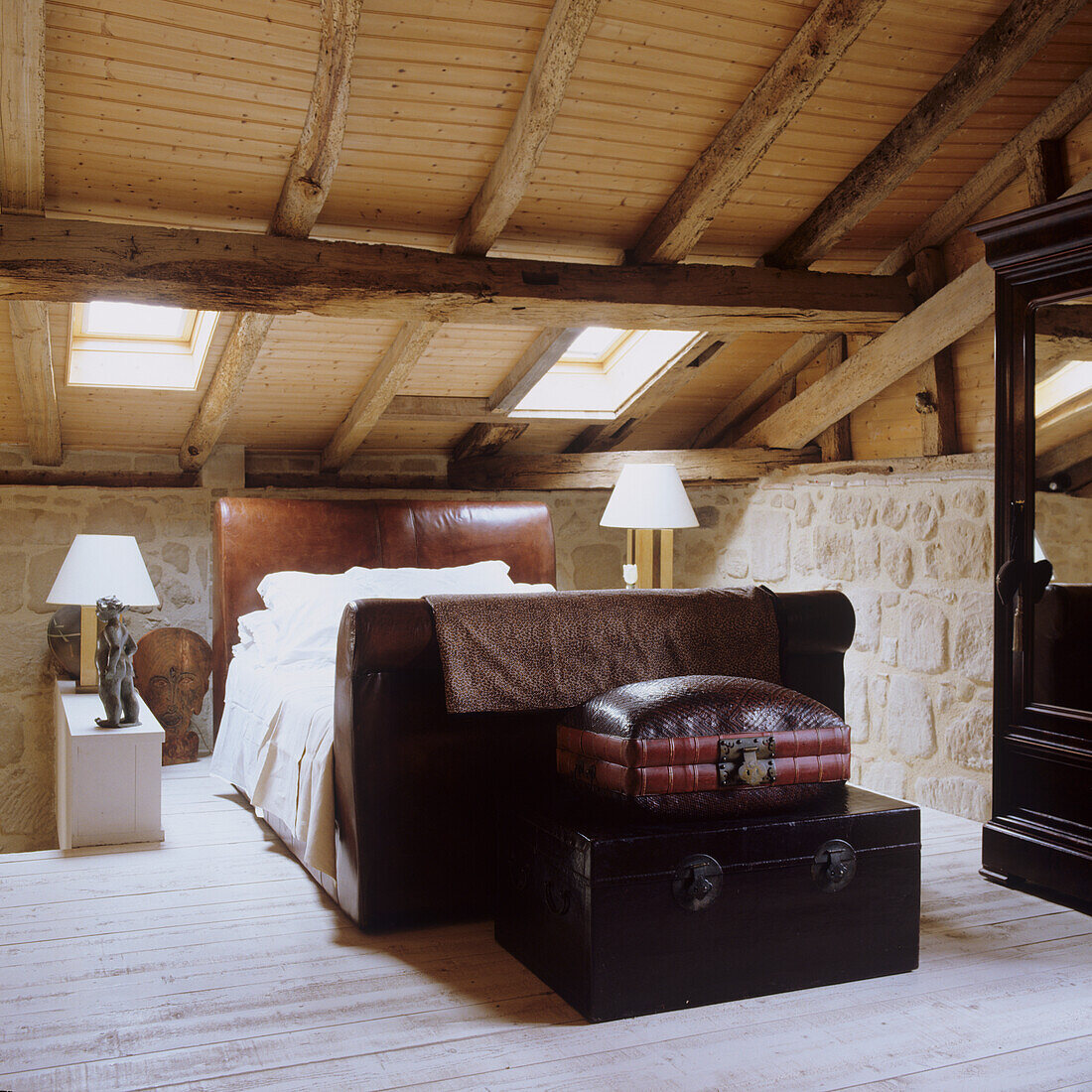 Bedroom in Mediterranean country house style with exposed wooden beams and skylights