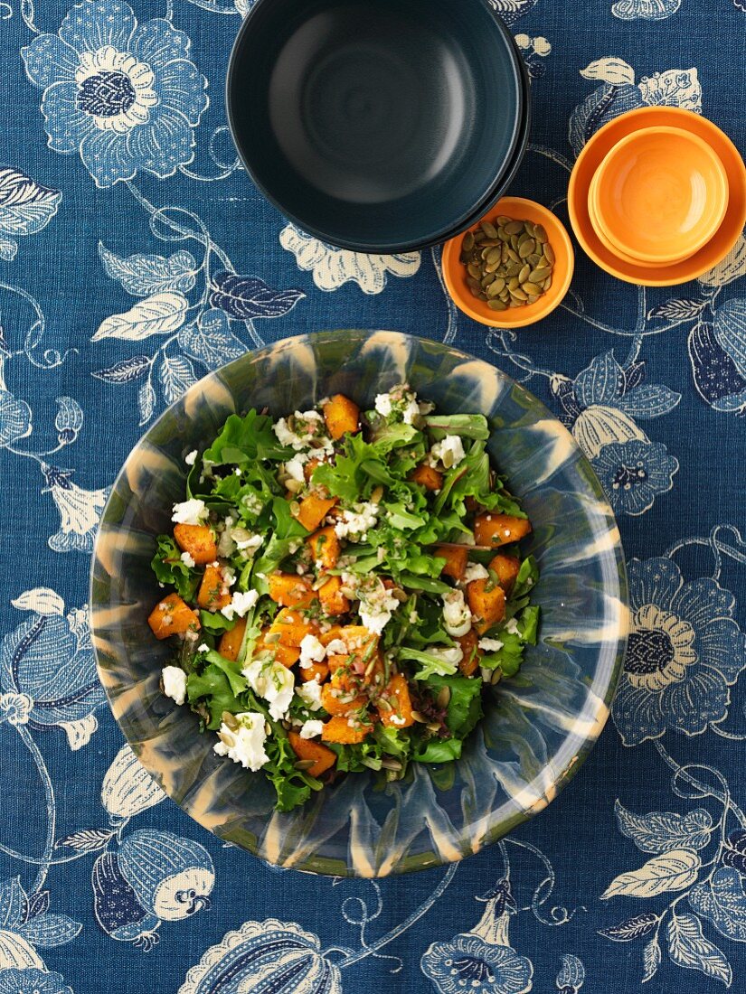 A mixed leaf salad with pumpkin and feta cheese