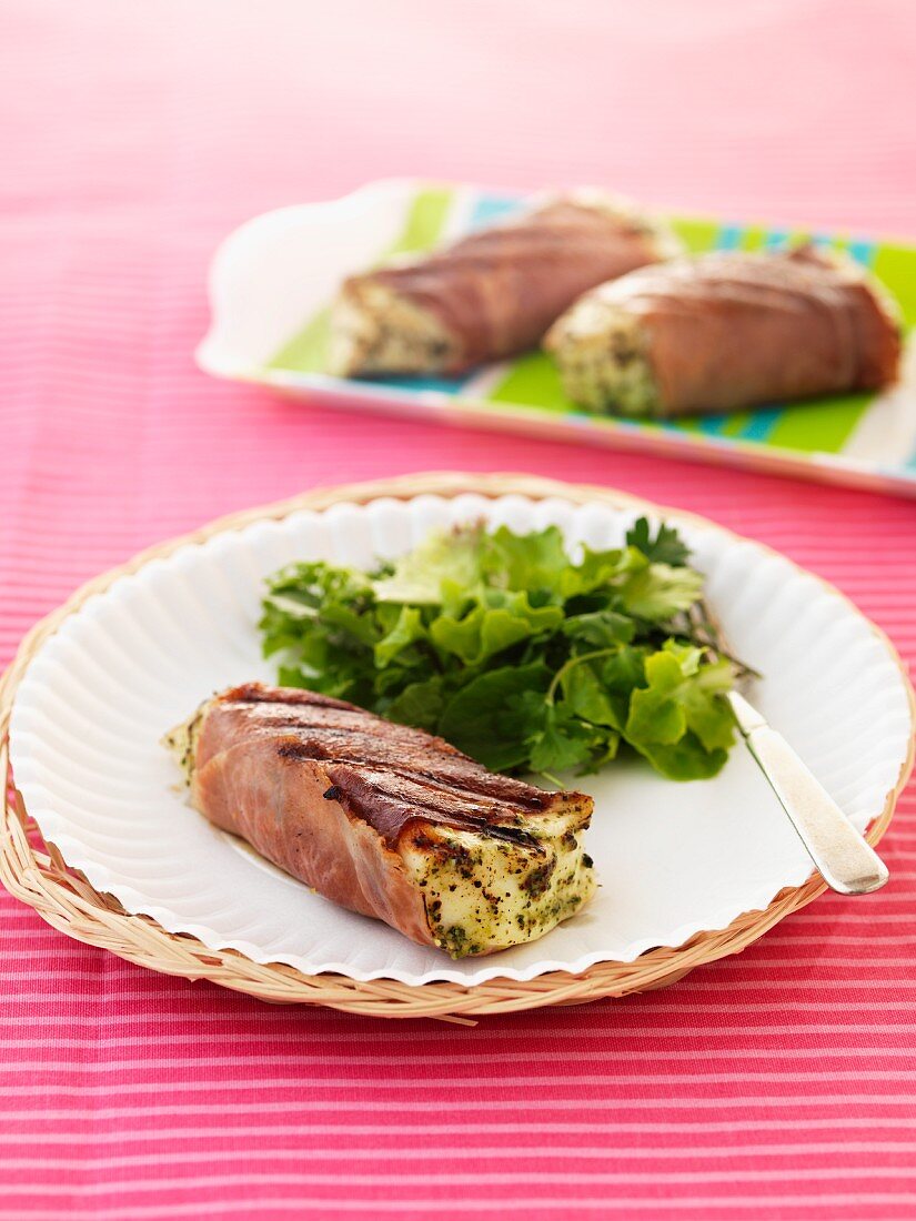 Halibut wrapped in ham with a mixed leaf salad