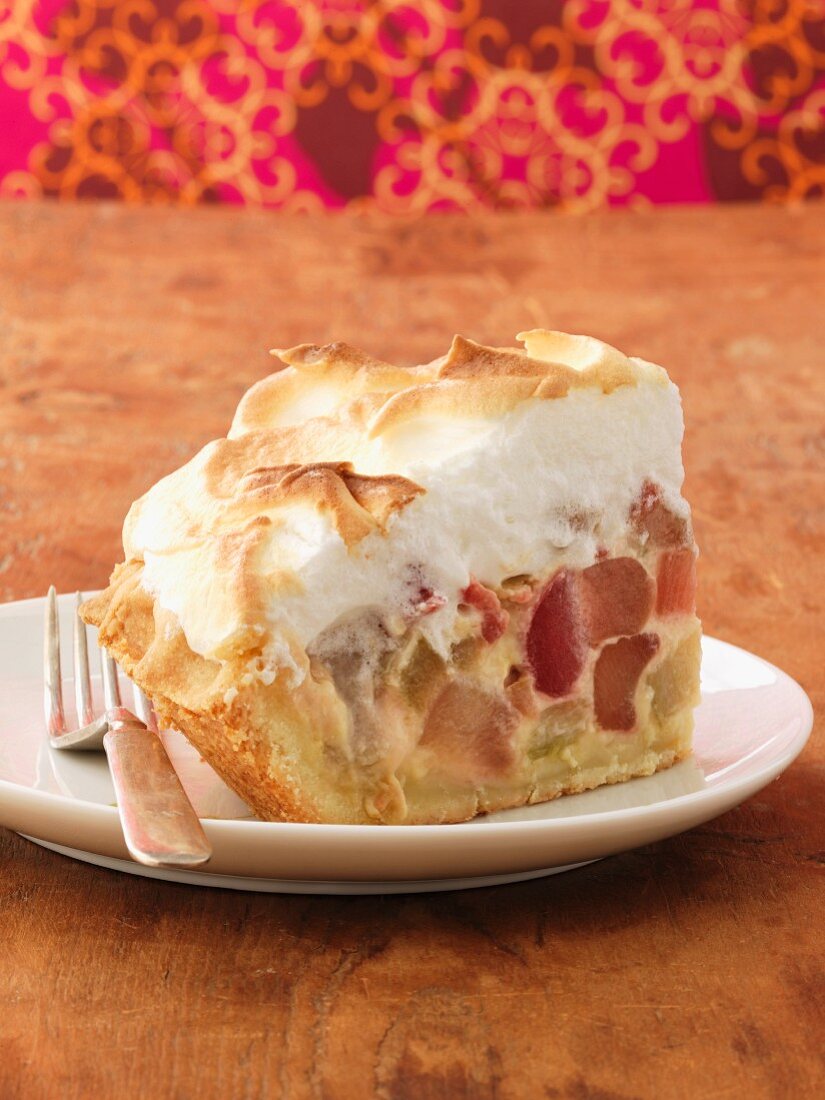A slice of rhubarb cake with a meringue topping