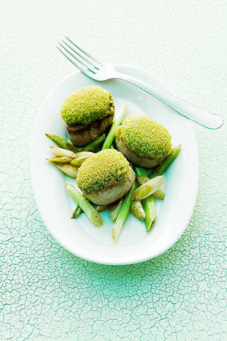 Schweinefilet mit Kräuter-Wasabi-Kruste auf Frühlingszwiebeln