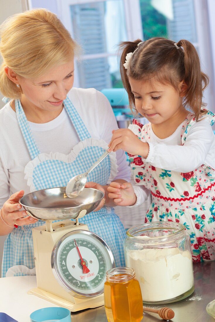 Mother and daughter baking in kitchen