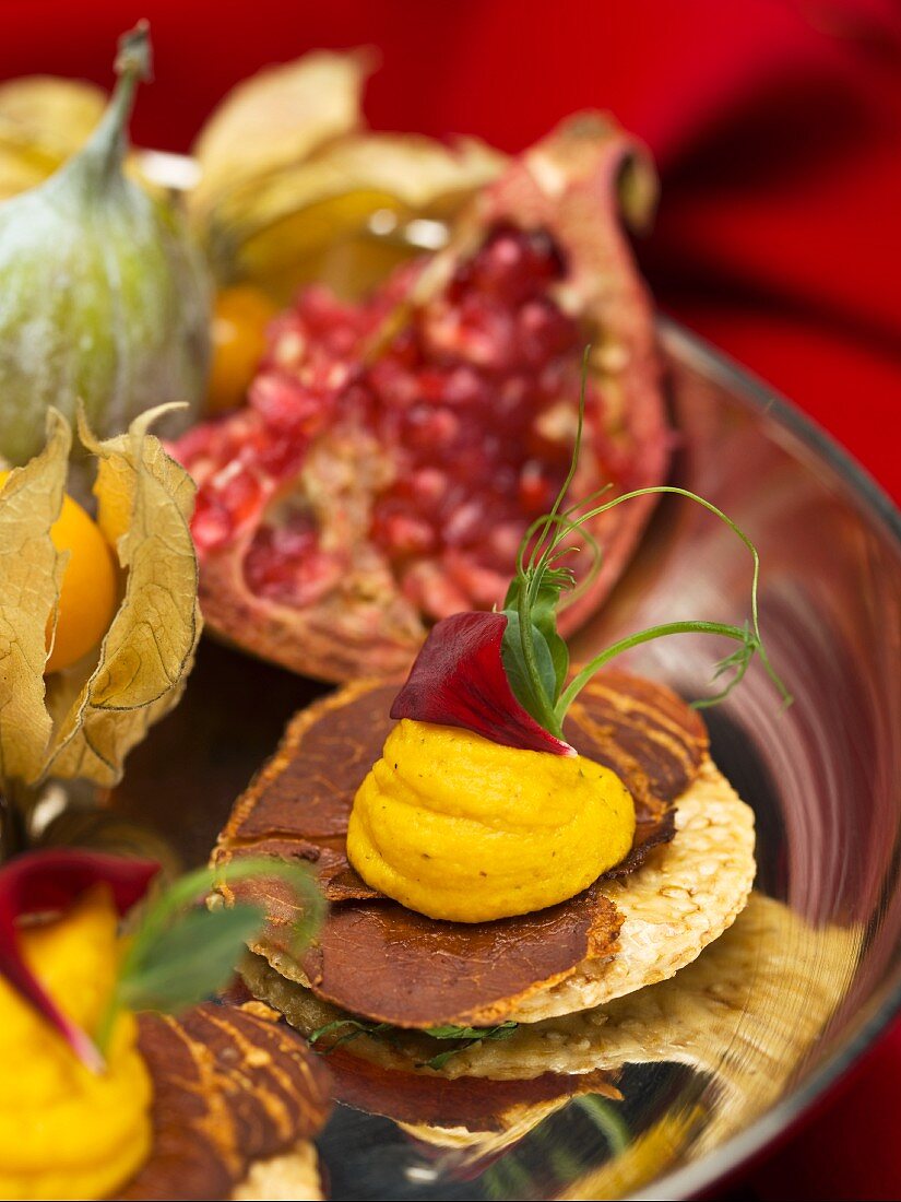 Canapes and exotic fruit on a cake stand