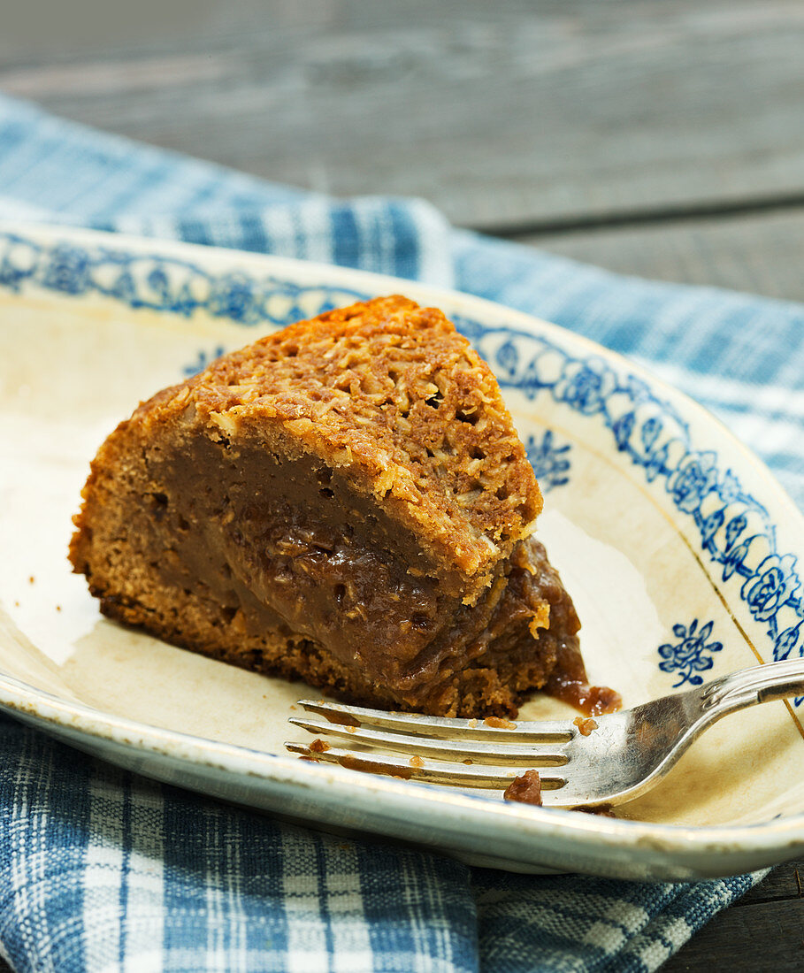 A slice of chocolate cake with a coconut crust