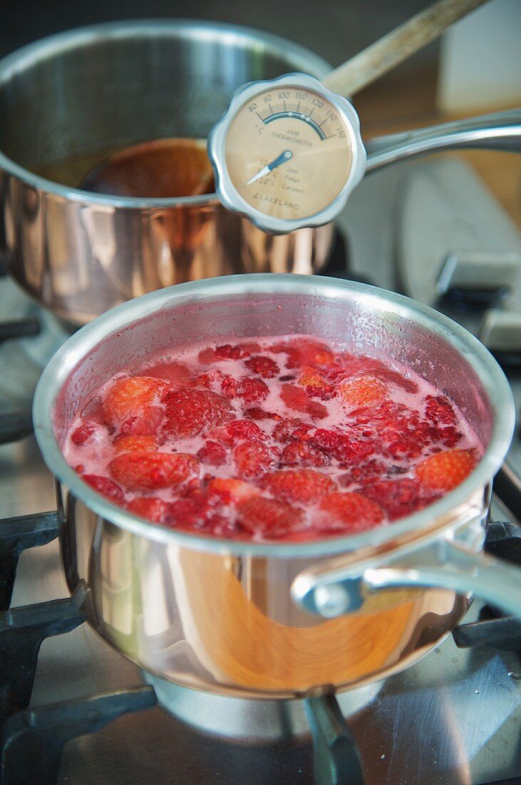Jam making: fruit cooking in a pot