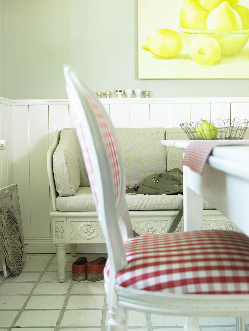 Country-style corner with checkered chairs and lemon still life painting