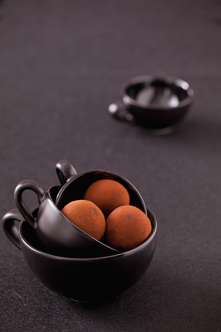 Chocolate truffles in black cups