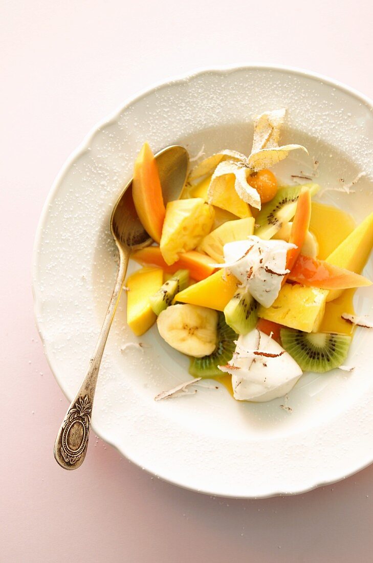 A fruit salad with yogurt dumplings and coconut
