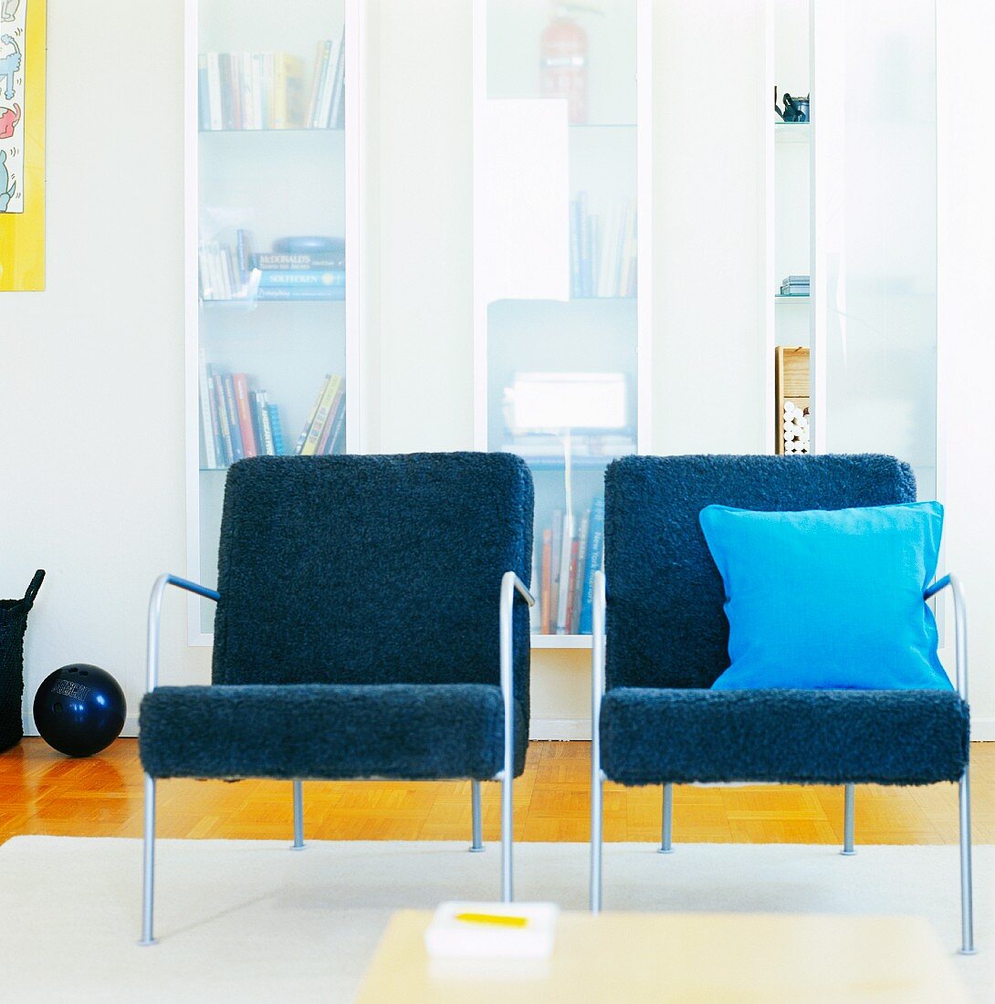 Two blue upholstered chairs in a living room