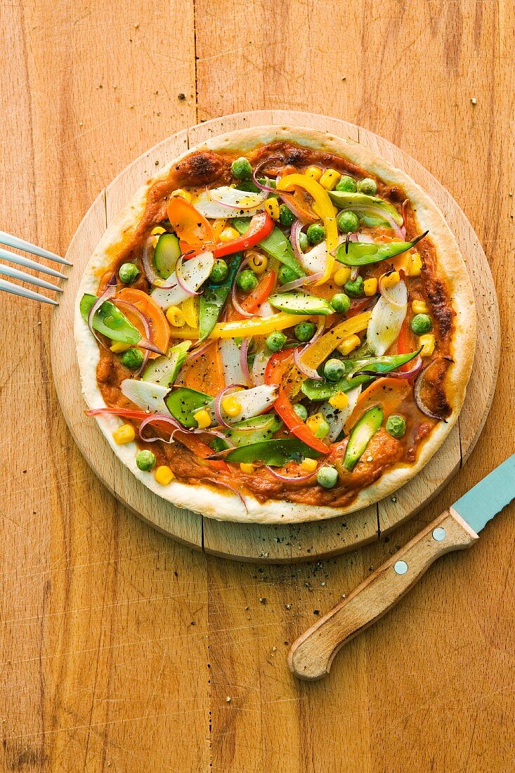 Pizza with asparagus, peppers, pees, corn and sugar snap peas