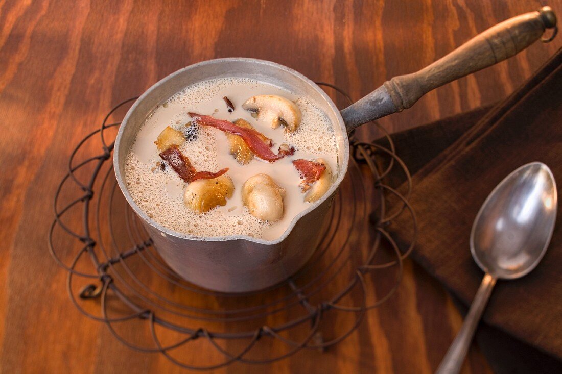 Mushroom soup with bacon in a pot