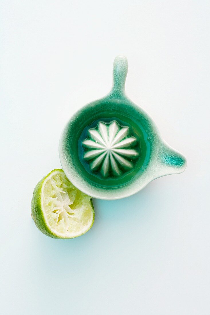 Limes and a citrus press