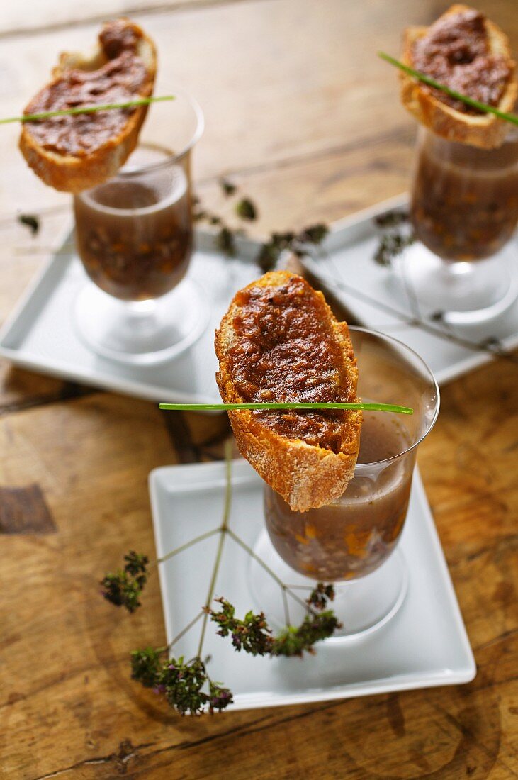 Clear venison soup with spicy venison pate crostini