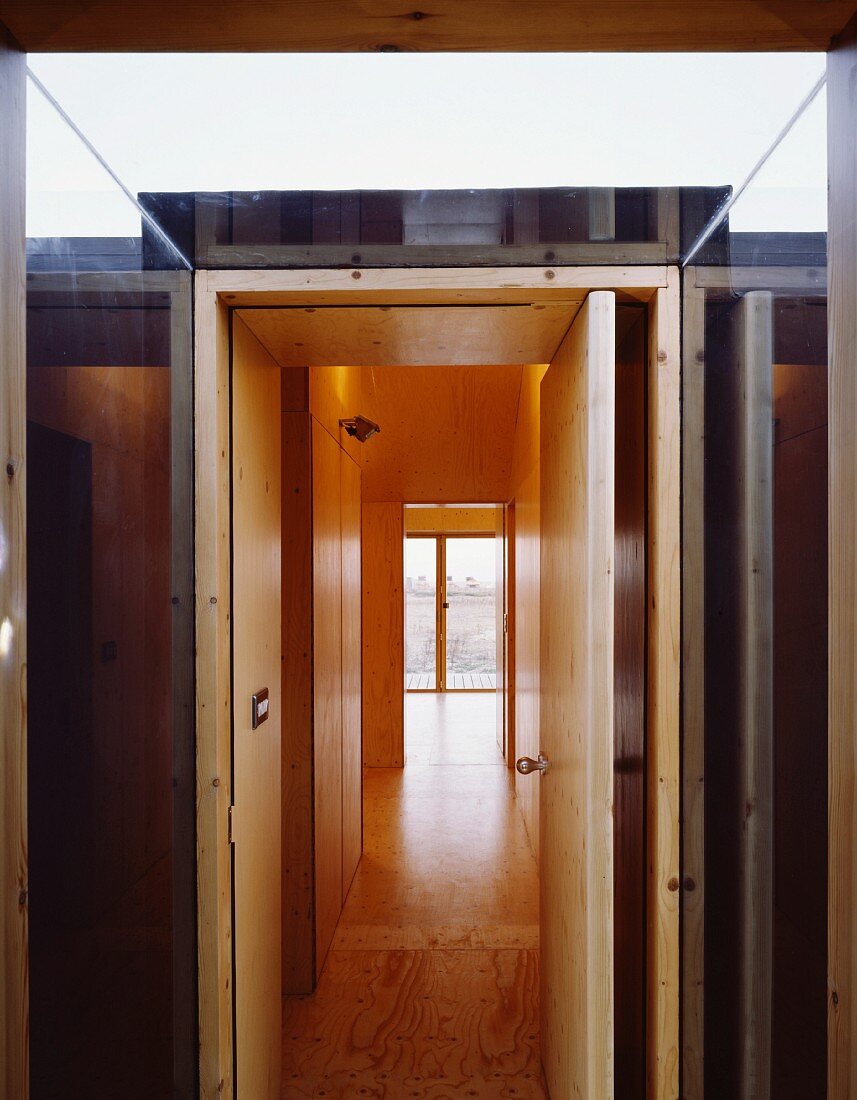 Glass porch with open front door and view of hallway