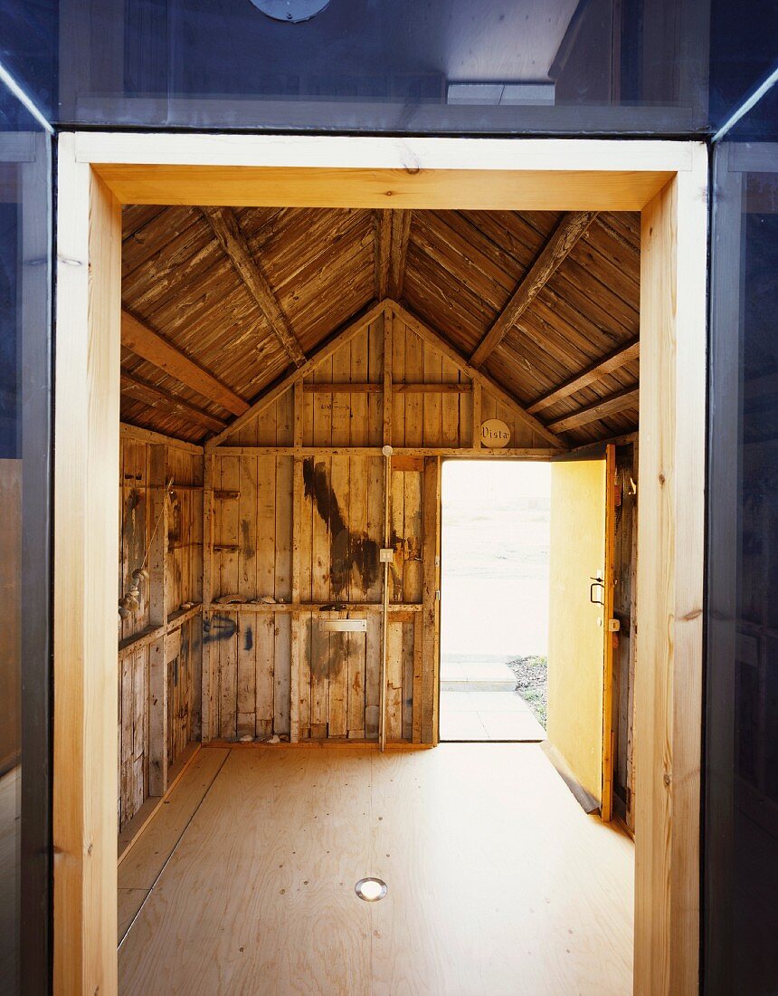 View through doorway into old, empty barn