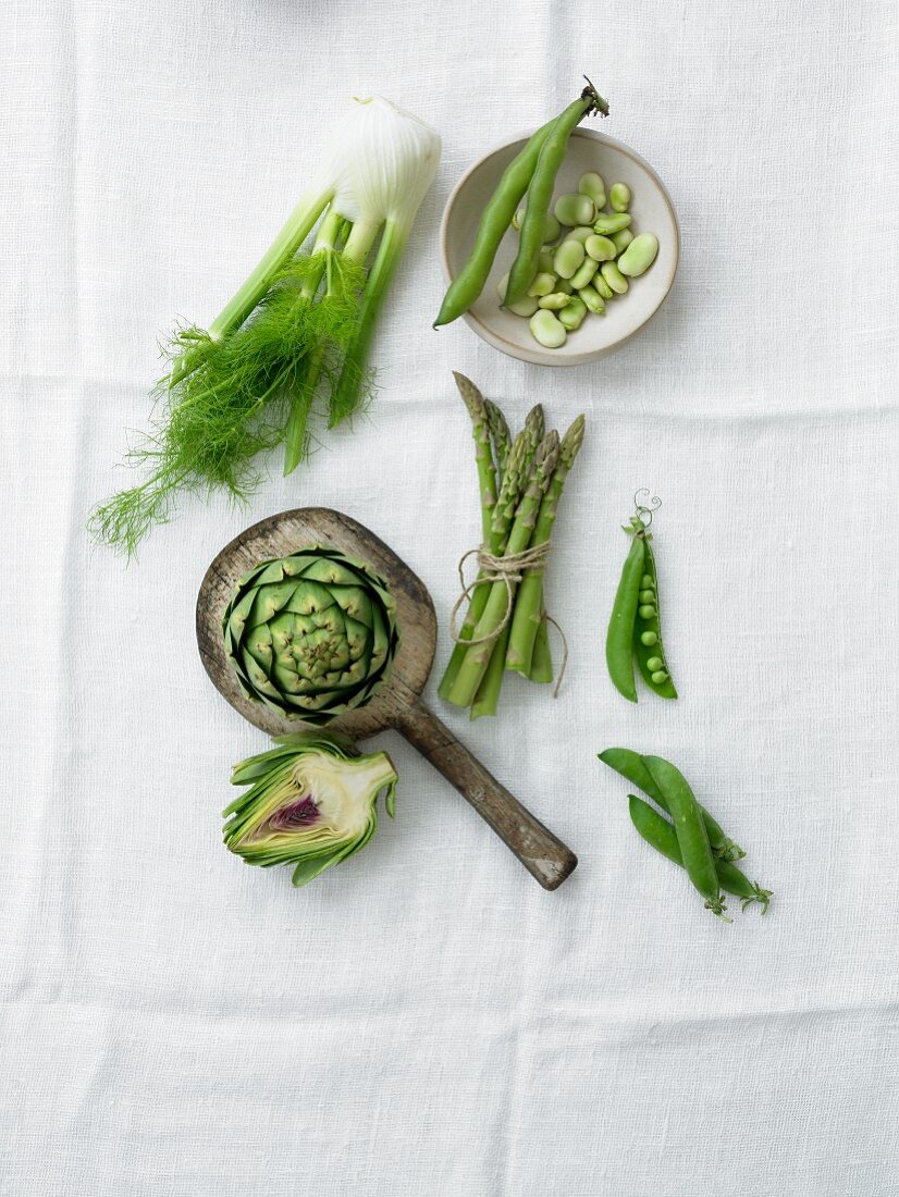 Assorted Green Vegetables on a White Cloth; From Above