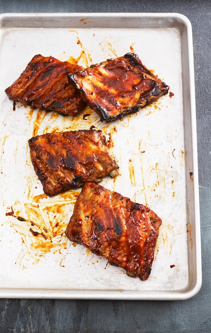 Marinated pork ribs on a baking tray