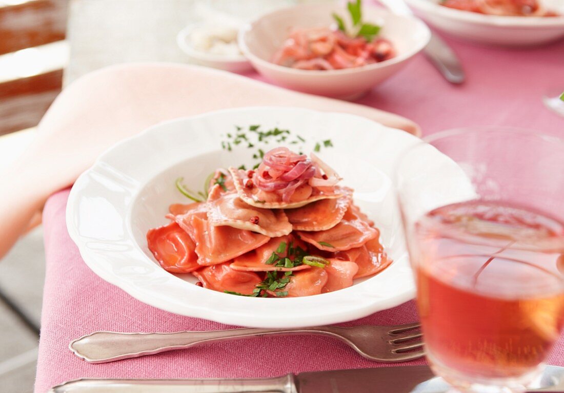 Pink ravioli with onions