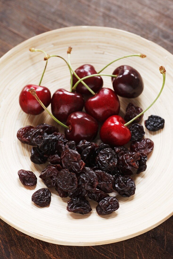 A plate of fresh and dried cherries