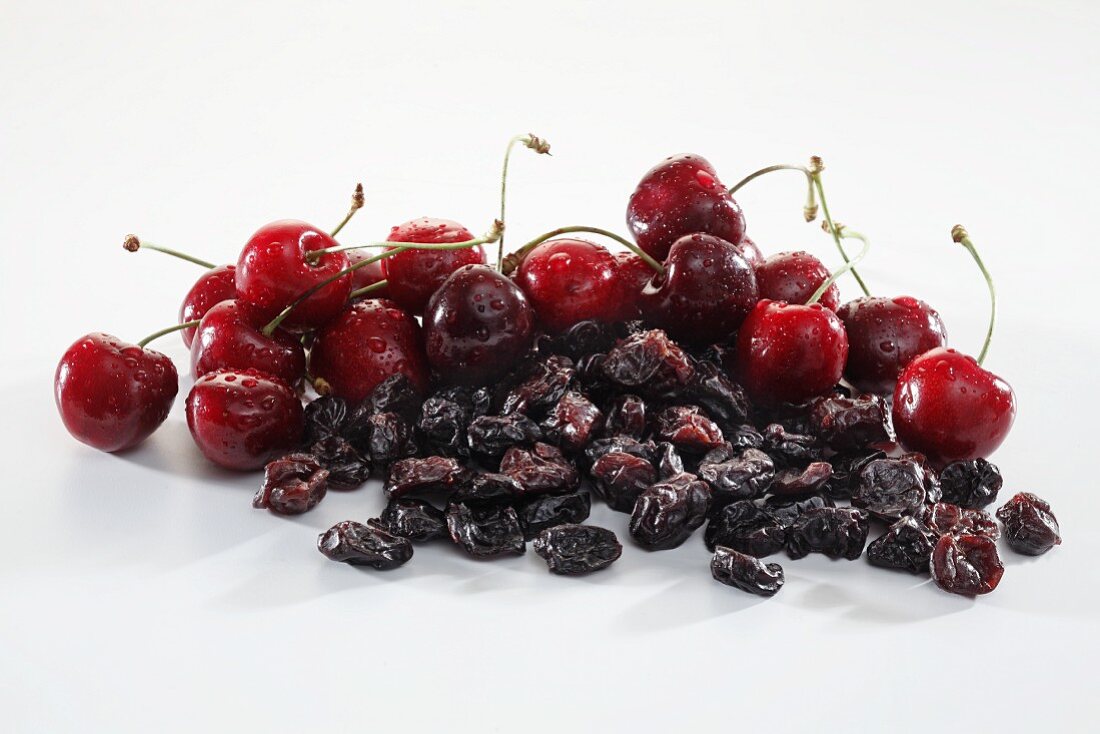 Small Wooden Bowl of Dried Cherries with a Fresh Cherry