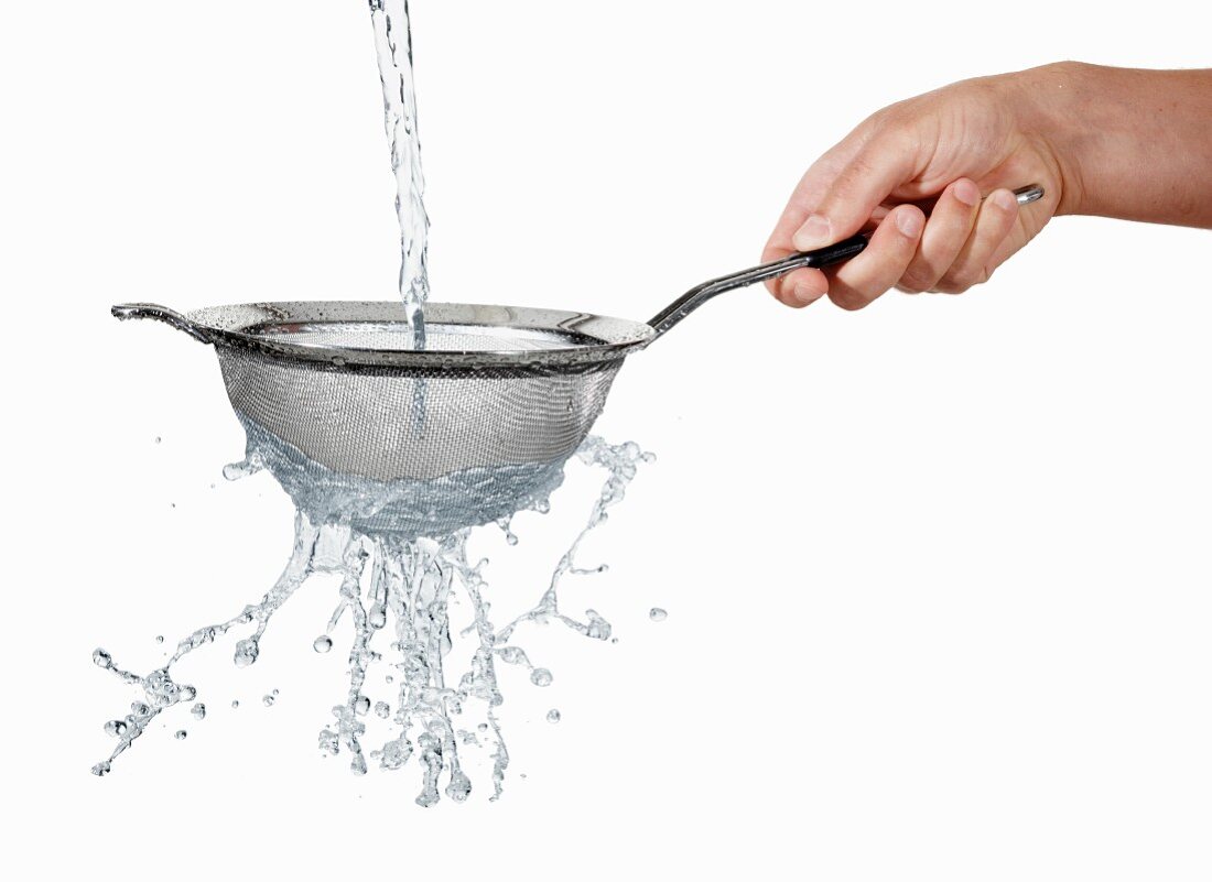 Stream of water running through a colander