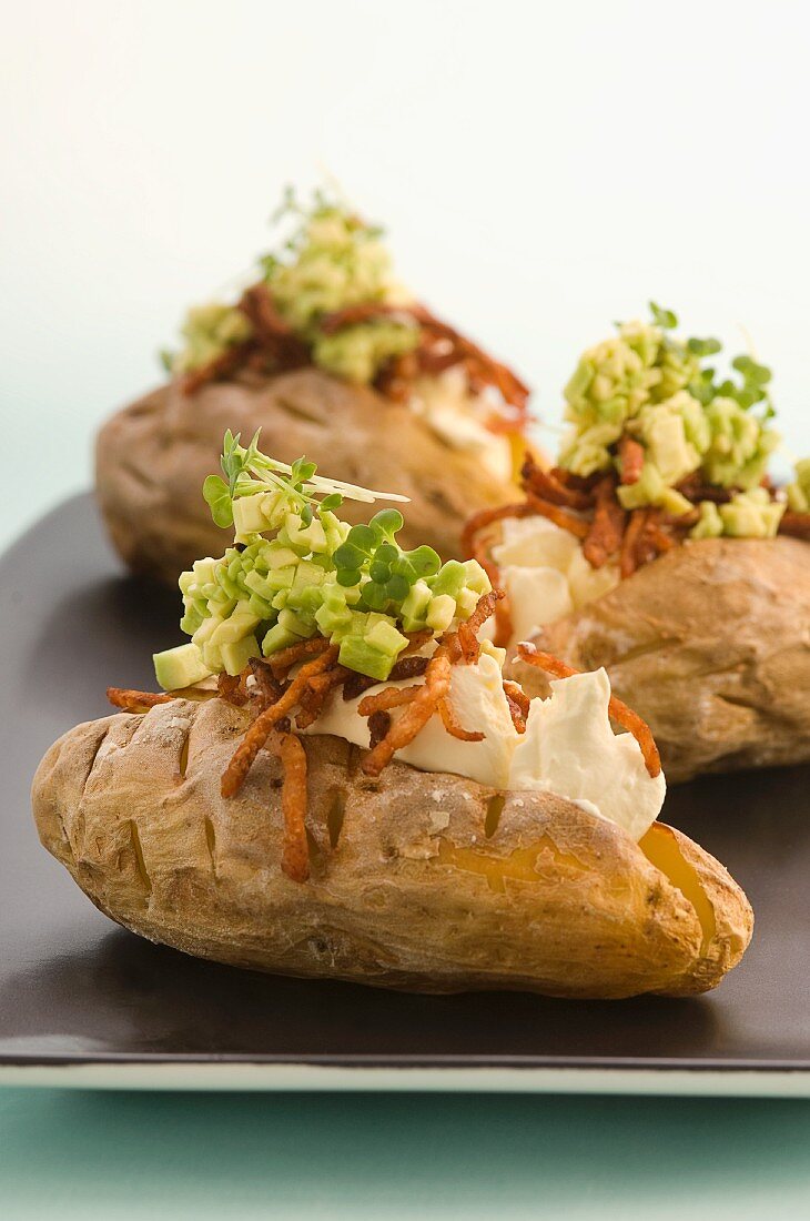 Baked potatoes with avocado and bacon