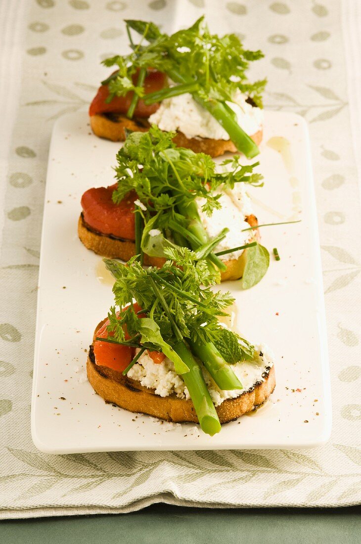 Bruschetta topped with goat's cheese and asparagus