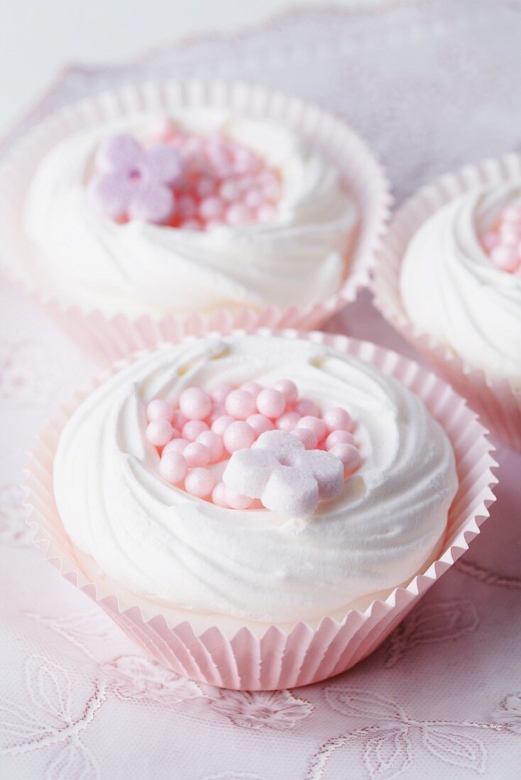 Meringue nests in muffin cases filled with sugar sprinkles