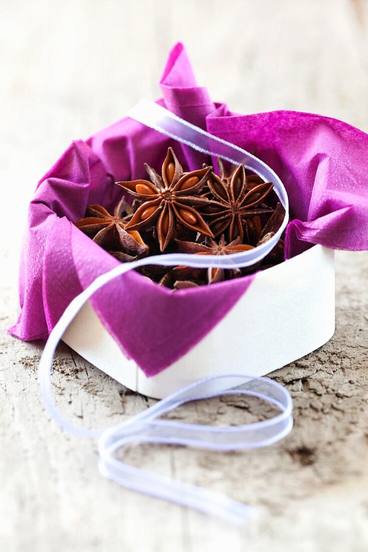 Anise stars in a gift box tied with ribbon