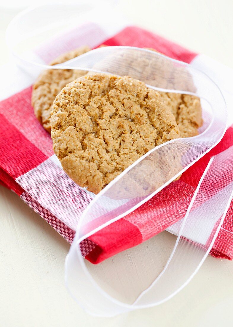 Oat biscuits tied with a ribbon on a kitchen towel