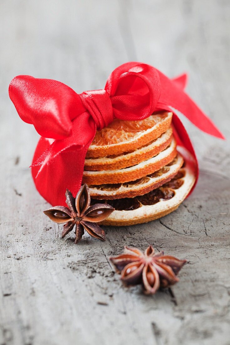 A stack of dried orange slices tied with a ribbon