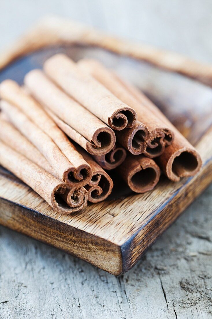 Cinnamon in a brown wooden bowl