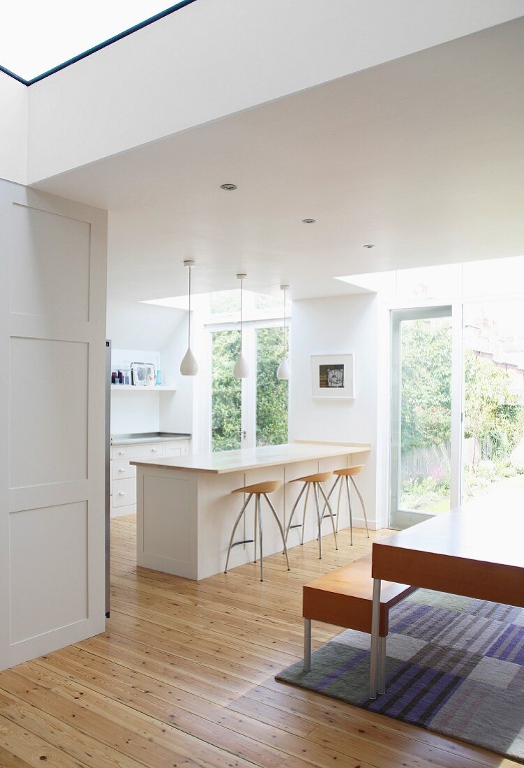 View of open-plan kitchen with island and dining table