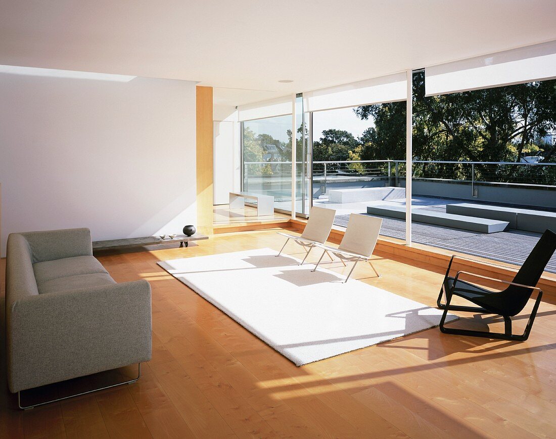 Large living room with seating and sliding glass doors leading to roof terrace