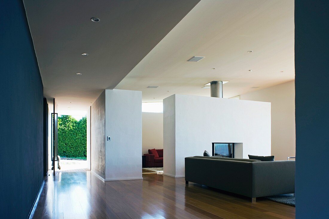 Open-plan living room with fireplace inserted into partition