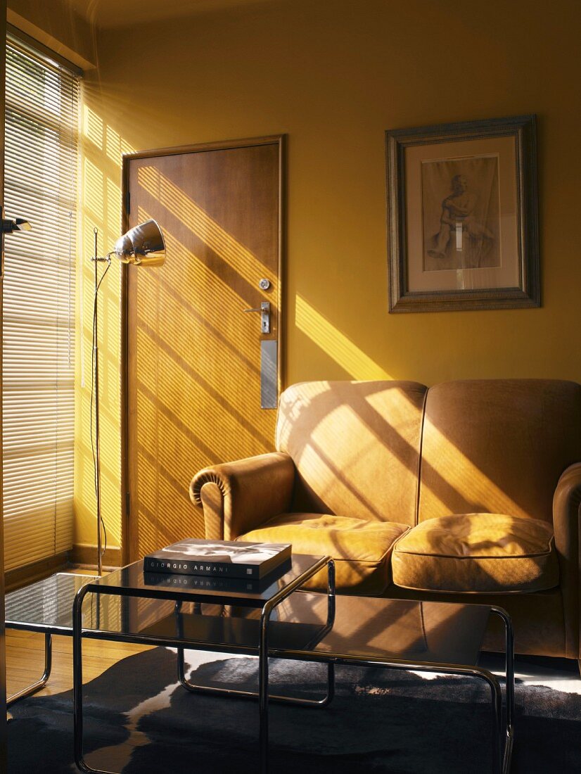 Living room with two-seater sofa in front of yellow wall