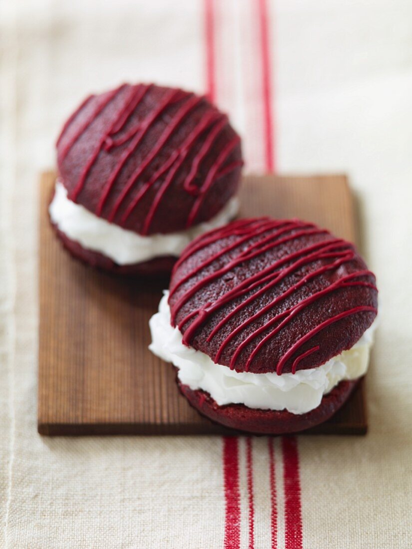 Two Red Velvet Whoopie Pies on a Board