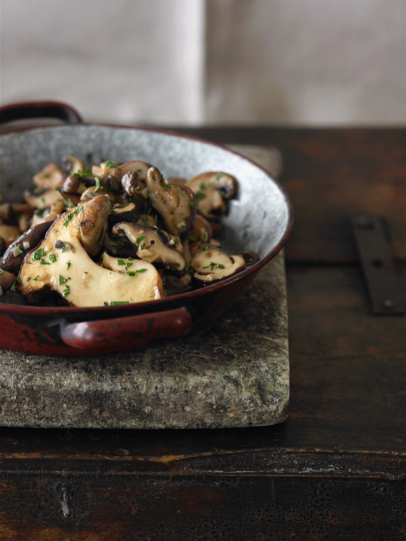 Sauteed Mushrooms in a Pan on a Stone Slab
