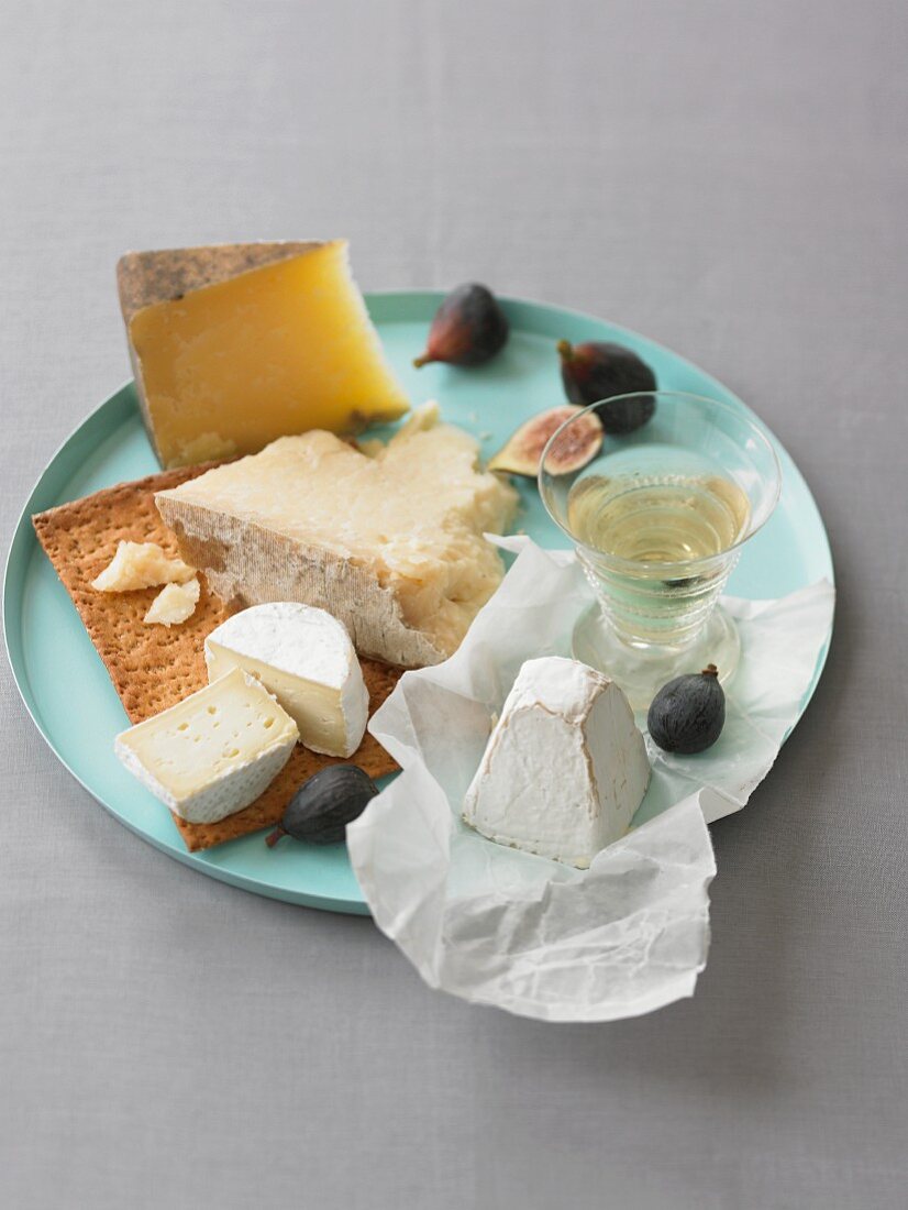 Assorted Cheese on a Teal Tray with Figs and White Wine