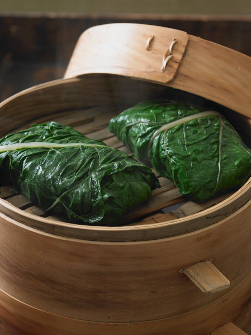 Steamed Fish Wrapped in Greens in Bamboo Steamer